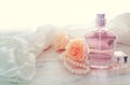 Beauty/fashion Image of elegant perfume bottle, white pearls and delicate roses over pastel background. vintage filtered image