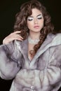 Beauty Fashion Model Girl in Blue Mink Fur Coat. Beautiful Luxury Winter Woman isolated on black background. Female with long Royalty Free Stock Photo