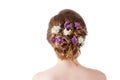 Beauty fashion model Girl with Lilac Flowers Hairstyle. Girl standing back. Royalty Free Stock Photo