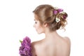 Beauty fashion model Girl with Lilac Flowers Hairstyle. Girl standing back. Royalty Free Stock Photo