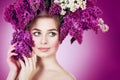 Spring woman portrait. Beauty girl with colorful wreath of lilac flowers in her hair Royalty Free Stock Photo