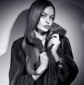 Beauty Fashion Model Girl in Mink Fur Coat black and white portrait. Beautiful Woman in Luxury Brown Fur Jacket posing in studio Royalty Free Stock Photo