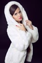 Beauty Fashion Model Girl in Mink Fur Coat and white furry hood. Royalty Free Stock Photo