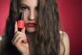 Beauty fashion model girl with red nailart and make up, hair and red background