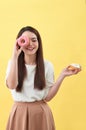 Beauty fashion model girl taking sweets and colorful donuts Royalty Free Stock Photo