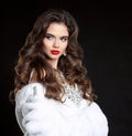Beauty Fashion Model Girl in white Mink Fur Coat. Red lips makeup. Beautiful Luxury winter woman with long curly hair style Royalty Free Stock Photo