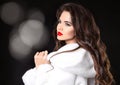 Beauty Fashion Model Girl in white Mink Fur Coat. Red lips makeup. Beautiful Luxury winter woman with long curly hair style Royalty Free Stock Photo