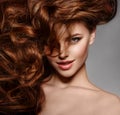 Beauty Fashion Model with long shiny hair. Waves & Curls volume