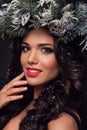 Beauty Fashion Model over Holiday. Beautiful girl with winter wreath. Royalty Free Stock Photo