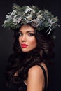 Beauty Fashion Model over Holiday. Beautiful girl with winter wreath. Royalty Free Stock Photo