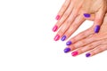 Beauty, fashion and Nail art concept. Manicure in nail spa salon -woman hands close-up with colored pink and purple gel nail polis