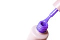 Beauty, fashion and Nail art concept. Manicure at salon - close-up bottle and brush of purple gel nail polish. on white b