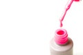 Beauty, fashion and Nail art concept. Manicure tools close-up bottle, brush and drop of pink gel nail polish. on white ba