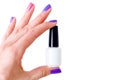 Beauty, fashion and Nail art concept. Woman hand with colorful manicure pink and purple colors close-up with white bottle of gel n