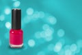 Beauty, fashion and nail art. Manicure art cosmetic tools, bottle of red colorful gel nail polish on blue bokeh background with