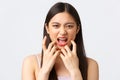 Beauty, fashion and people emotions concept. Close-up portrait of angry, mad and pissed-off asian woman, grimacing Royalty Free Stock Photo