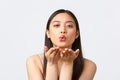 Beauty, fashion and people emotions concept. Close-up portrait of passionate, romantic asian woman sending air kiss at