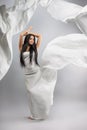 Beauty fashion photo of young beautiful girl in a flying white cloth. Royalty Free Stock Photo