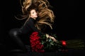 Beauty fashion portrait. Beautiful woman with makeup and rose flowers. Beautiful seductive woman holding large bouquet Royalty Free Stock Photo