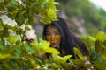 Beauty fashion portrait of young happy and beautiful Asian Korean woman in hipster sunglasses playing with tree branches feeling Royalty Free Stock Photo