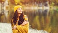 Beauty and fashion. Romantic woman in autumn. Pretty tenderness girl wearing warm autumn clothes, hat and yellow scarf. Girl Royalty Free Stock Photo