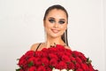 Beauty fashion sensual girl with big bouquet of red roses. Glamour sexy woman with fashion bright makeup. Valentine`s day Royalty Free Stock Photo