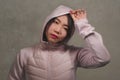 Beauty and fashion style isolated portrait of young beautiful and cool Asian Chinese student woman in pink hood winter jacket Royalty Free Stock Photo