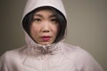 Beauty and fashion style isolated portrait of young beautiful and cool Asian Korean student woman in pink hood winter jacket in Royalty Free Stock Photo