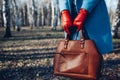 Beauty and fashion. Stylish fashionable woman wearing bright dress holding brown bag handbag Royalty Free Stock Photo