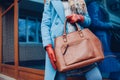 Beauty and fashion. Stylish fashionable woman wearing coat and gloves ,holding brown bag handbag Royalty Free Stock Photo