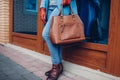 Beauty and fashion. Stylish fashionable woman wearing coat and gloves ,holding brown bag handbag Royalty Free Stock Photo