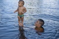 Manaus, Amazonas, Brazil - August 16, 2016: Father hold newborn baby in the waters of Amazon River, in the TupÃÂ© Beach