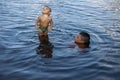 Manaus, Amazonas, Brazil - August 16, 2016: Father hold newborn baby in the waters of Amazon River, in the TupÃÂ© Beach