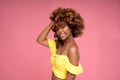 Beauty female portrait of smiling happy afro hairstyle girl in glamour summer makeup. Pink background Royalty Free Stock Photo