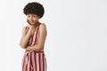 Beauty, feminine and fashion concept. Indoor shot of cute and tender African American woman with afro hairstyle leaning