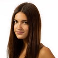 Beauty feminine portrait of female face with healthy natural skin. Beautiful tanned teen girl with long brown hair