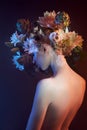 Beauty flowers face of a woman with double exposure. Portrait of a girl neon light and color, professional makeup, nude back of a