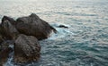 Beauty and force of deep water. Danger o swimming in forbidden places. Wild sea panorama surrounded with sharp rock stones in Royalty Free Stock Photo