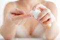 Beauty girl applying some white lotion on forefinger of her hand Royalty Free Stock Photo