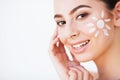 Sun Tanning. Beauty Girl Applying Sun Tan Cream on her Face. Royalty Free Stock Photo
