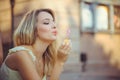 Beauty girl with colorful soap bubbles laughing. Beautiful happy young woman on a sunny bright day. Joyful model plays with soap Royalty Free Stock Photo