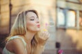 Beauty girl with colorful soap bubbles laughing. Beautiful happy young woman on a sunny bright day. Joyful model plays with soap Royalty Free Stock Photo