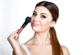 Beauty Girl make up artist with Makeup Brush. Bright Holiday Make-up for Brunette Woman with Brown Eyes. Beautiful Face. Makeover Royalty Free Stock Photo