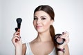 Beauty Girl make up artist with Makeup Brush. Bright Holiday Make-up for Brunette Woman with Brown Eyes. Beautiful Face. Makeover Royalty Free Stock Photo