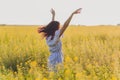 Beauty Girl Outdoors enjoying nature. Beautiful Teenage Model girl in dress running on the Spring Field, Sun Light. Royalty Free Stock Photo