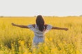 Beauty Girl Outdoors enjoying nature. Beautiful Teenage Model girl in dress running on the Spring Field, Sun Light. Royalty Free Stock Photo