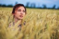 Beauty Girl Outdoors enjoying nature. Beautiful Teenage Model girl in dress on the Spring Field Royalty Free Stock Photo