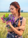 Beauty Girl Outdoors enjoying nature. Beautiful Teenage Model girl in dress on the Spring Field Royalty Free Stock Photo