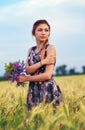 Beauty Girl Outdoors enjoying nature. Beautiful Teenage Model girl in dress on the Spring Field Royalty Free Stock Photo