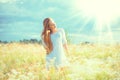 Beauty girl outdoors enjoying nature. Beautiful teenage model girl with healthy long hair in white dress Royalty Free Stock Photo